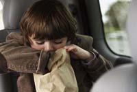 600-01123709© MasterfileModel ReleaseBoy Sitting in Car Looking inPaper Bag